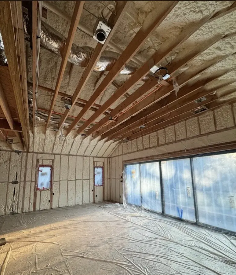 Interior walls and ceiling insulated with spray foam during new construction in Freehold